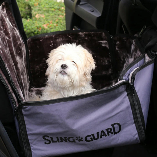 Dog inside a car with a Sling Guard pet seat cover.