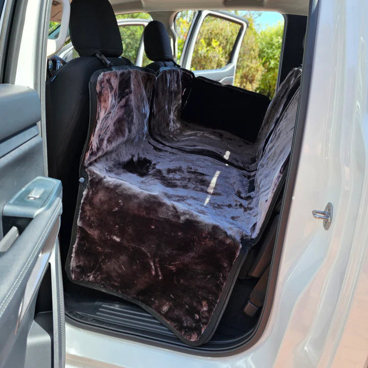 Car interior with a brown pet seat cover on the back seat